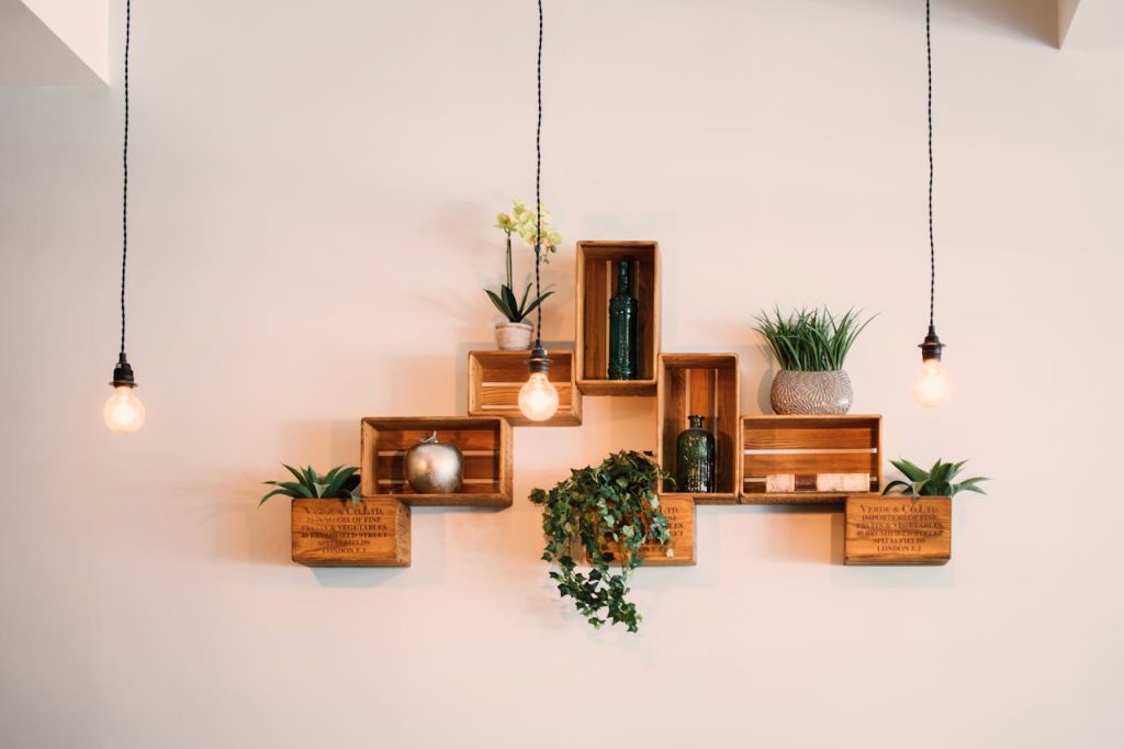 pexels photo 1090638 Contemporary wooden shelves with plants and decor, illuminated by hanging lights.